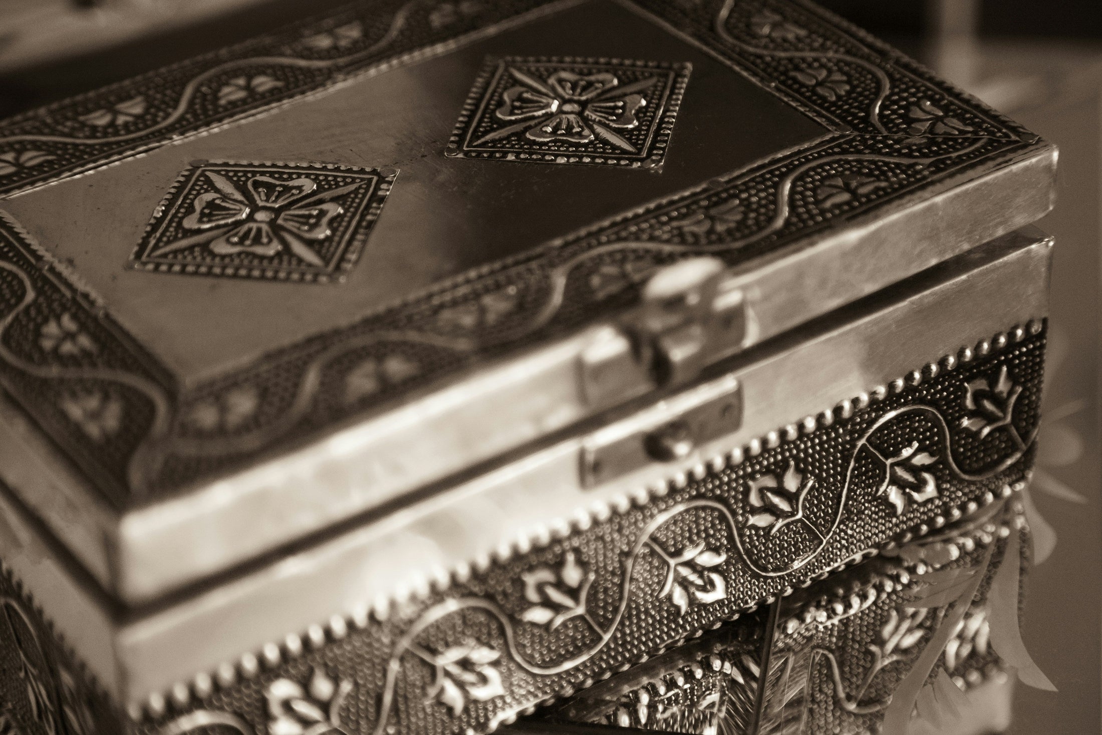 Ornate vintage metal keepsake box with embossed floral pattern in sepia tone, representing photo keepsake Christmas gifts made with wholesale sublimation jewelry box blanks