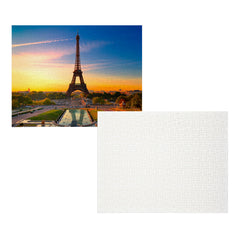 A square jigsaw puzzle featuring a scenic view of the Eiffel Tower in Paris at sunset, shown next to its blank white textured puzzle piece backing on a solid white background.